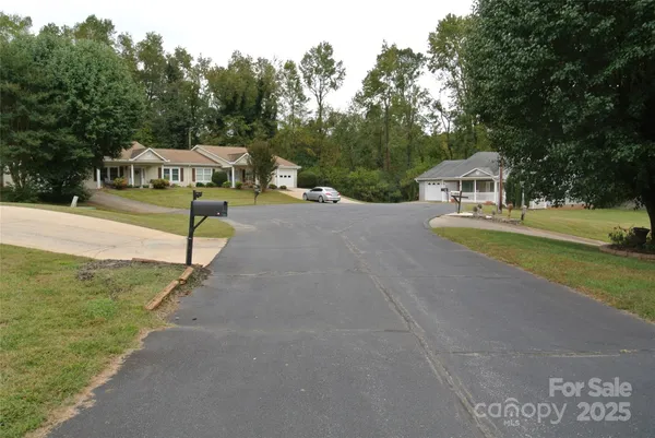 a view of a house with garden and trees