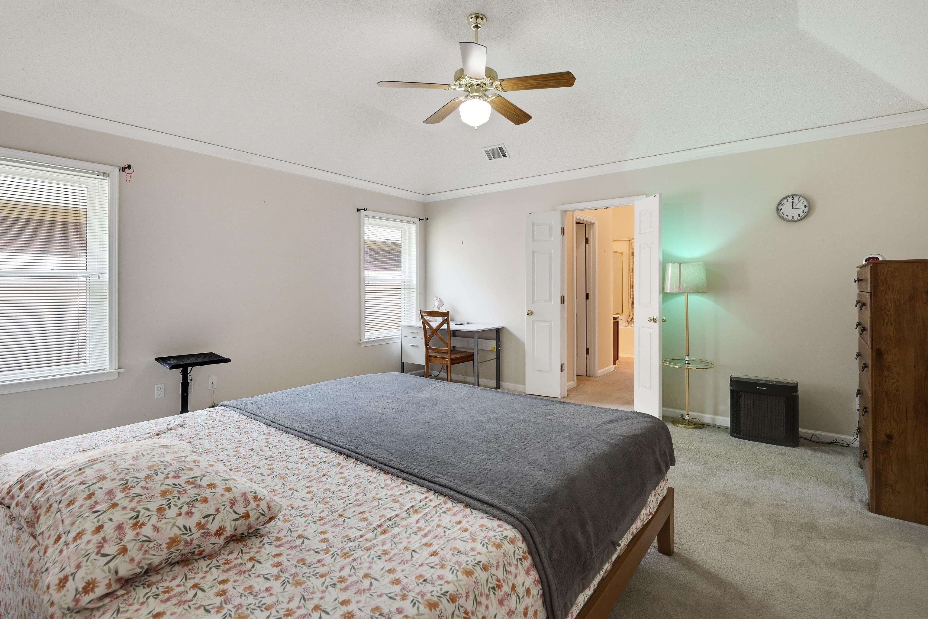 954 Wildbird Cove Collierville, TN 38017 - Photo 19 of 32 a large bedroom with a bed and a chandelier