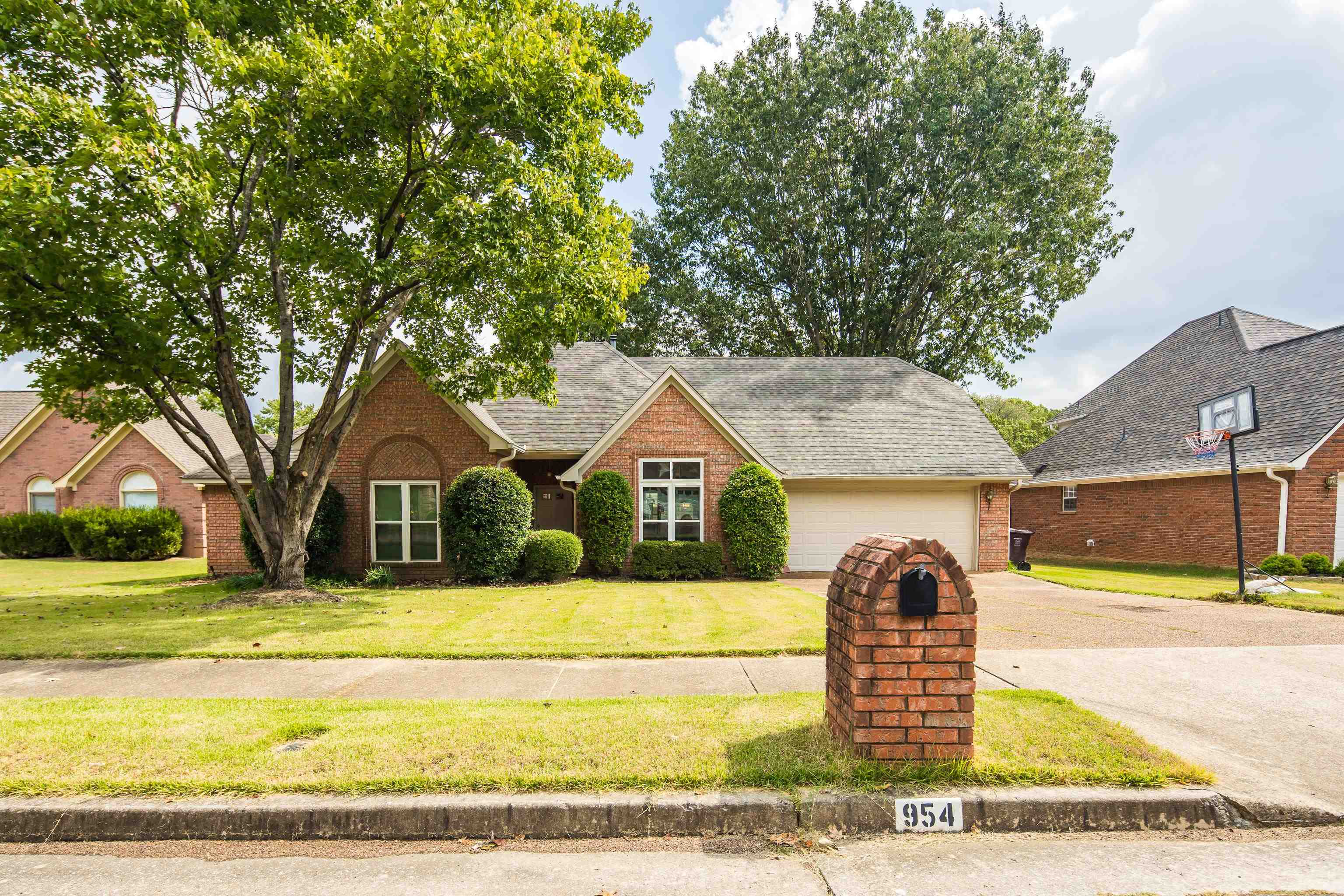 954 Wildbird Cove Collierville, TN 38017 - Photo 2 of 32 a front view of a house with a yard
