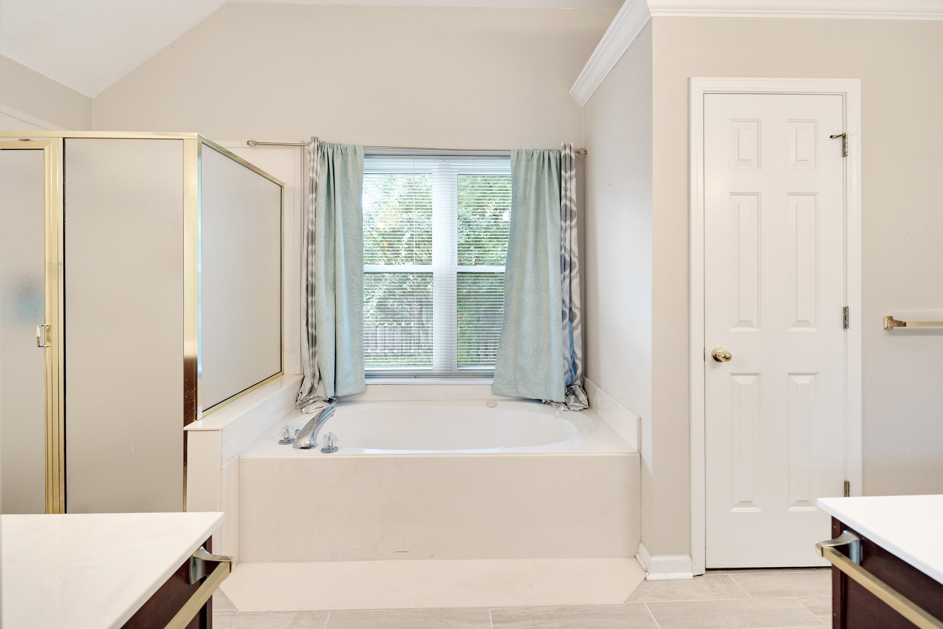 954 Wildbird Cove Collierville, TN 38017 - Photo 21 of 32 a bathroom with a bathtub and a shower
