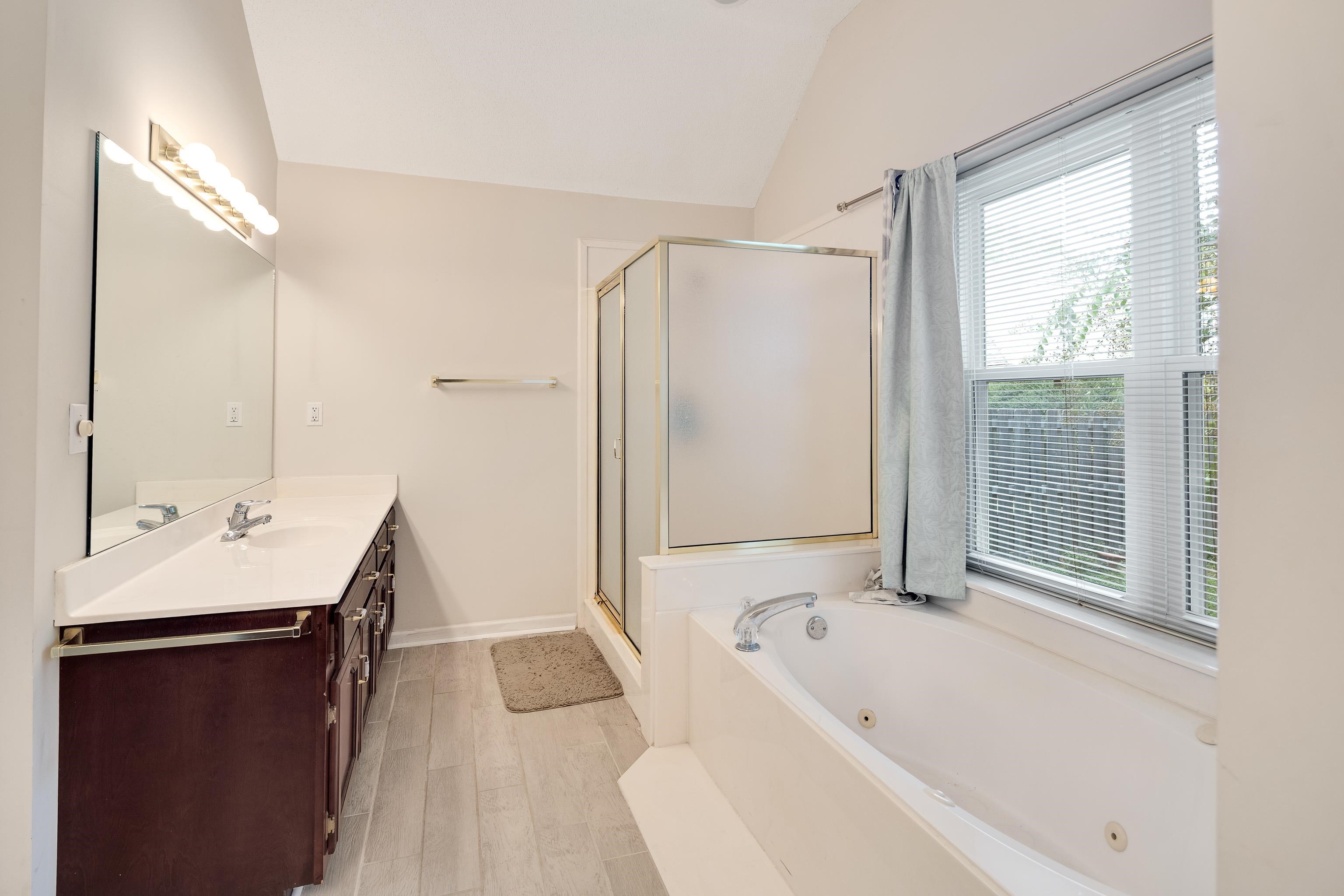954 Wildbird Cove Collierville, TN 38017 - Photo 22 of 32 a bathroom with a tub sink and mirror