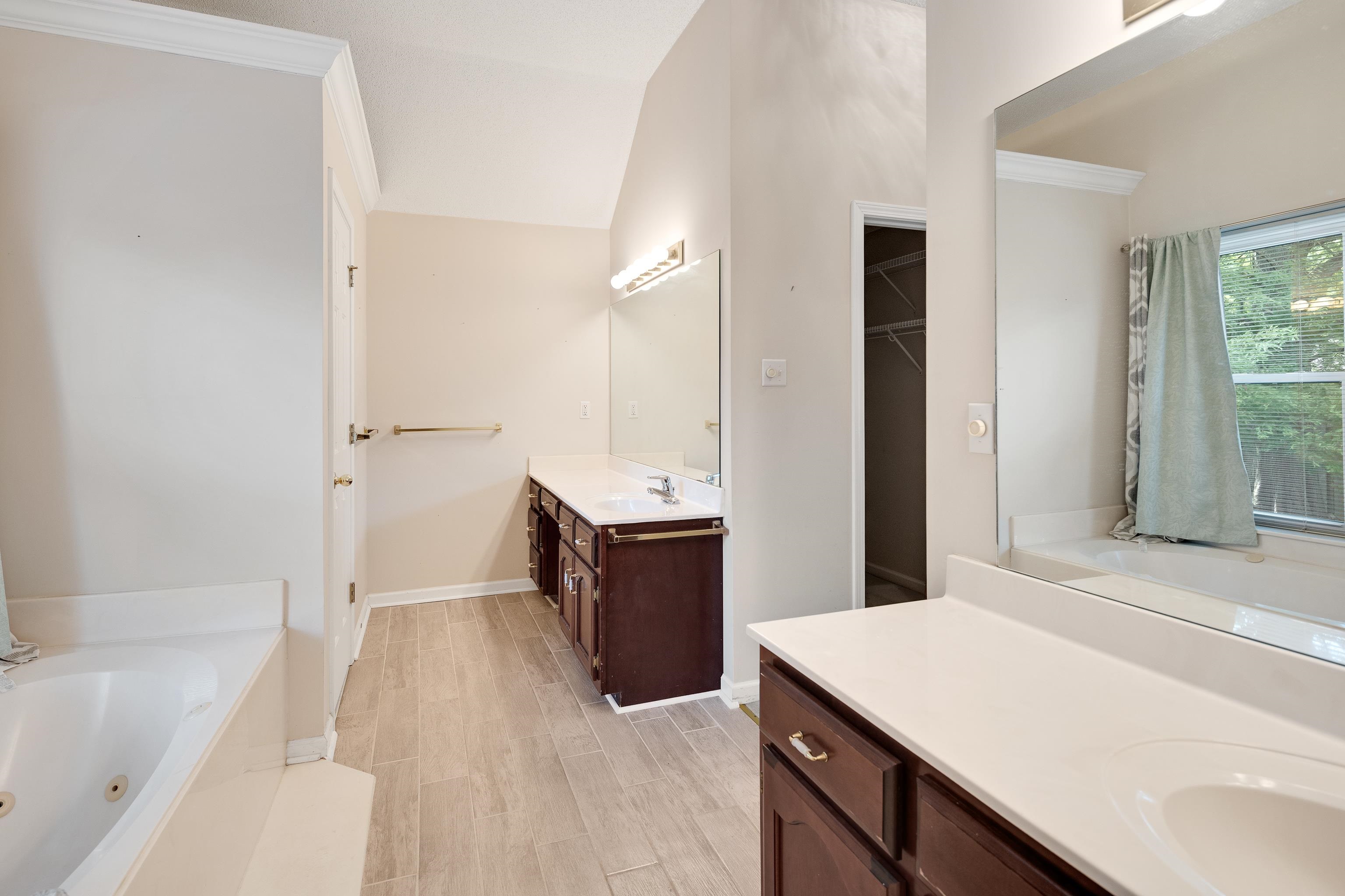 954 Wildbird Cove Collierville, TN 38017 - Photo 23 of 32 a spacious bathroom with a tub sink and mirror