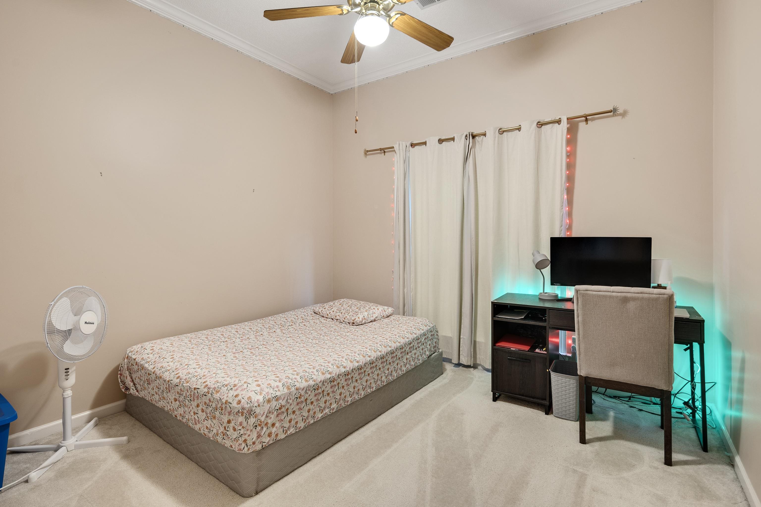 954 Wildbird Cove Collierville, TN 38017 - Photo 27 of 32 a bedroom with a bed and a television