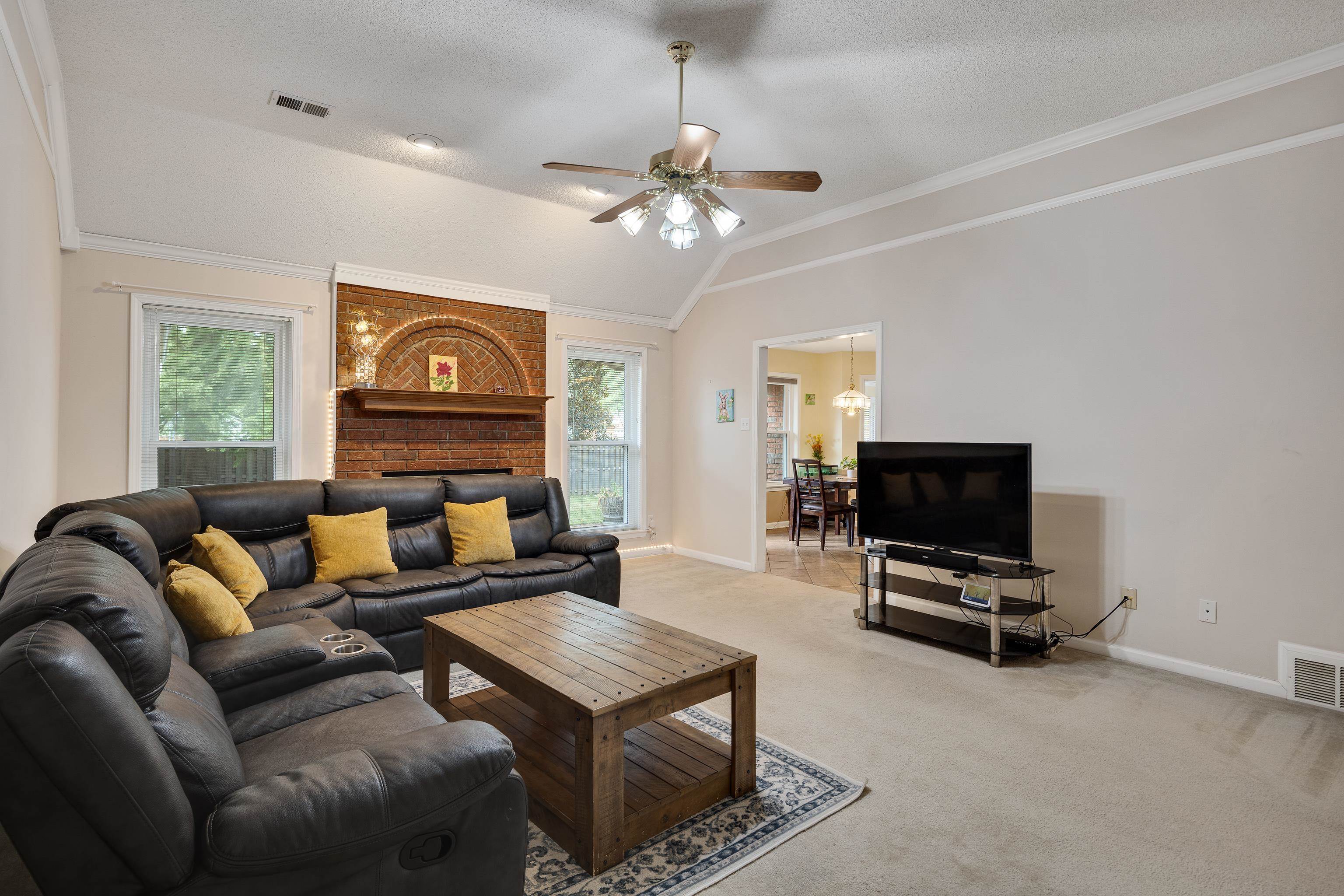 954 Wildbird Cove Collierville, TN 38017 - Photo 8 of 32 a living room with furniture a flat screen tv and a window