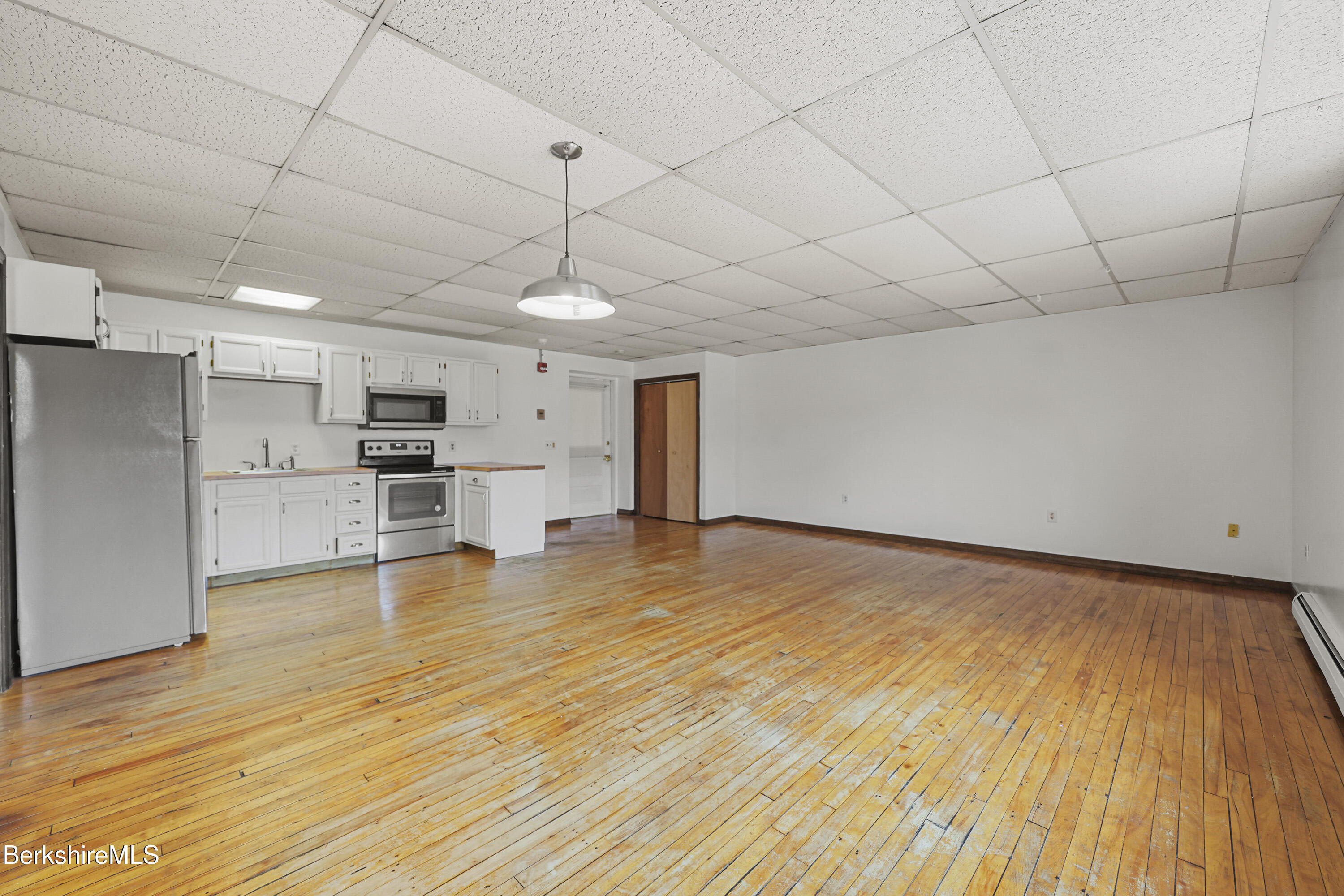 55 Crystal Street, Unit 8 Lenox, MA 01242 - Photo 6 of 12 a view of empty room with wooden floor