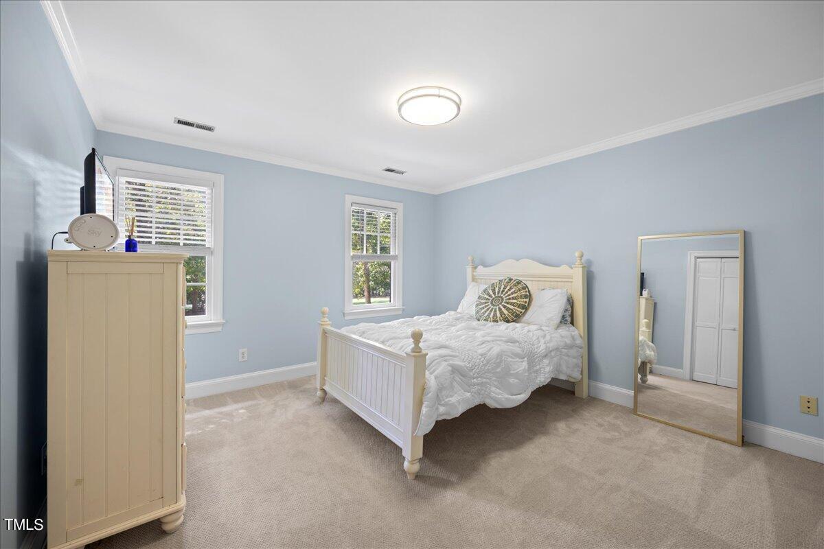 10036 Old Warden Road Raleigh, NC 27615 - Photo 30 of 42 a bed room with a bed and a window
