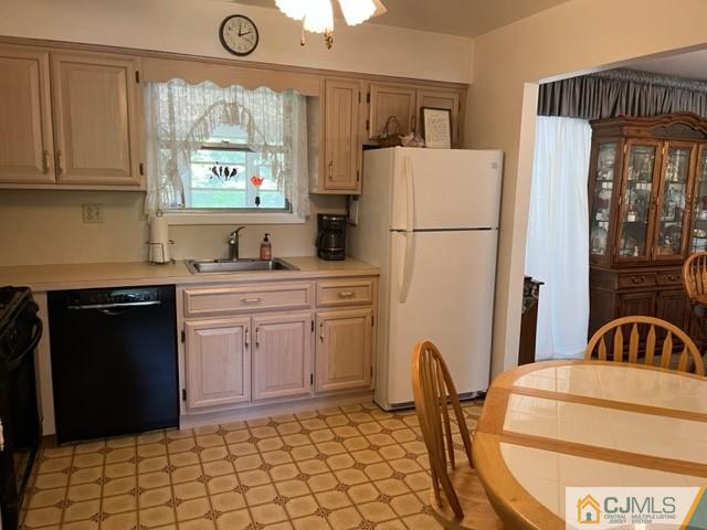 730 Lawrence Road Bound Brook, NJ 08805 - Photo 3 of 23 a kitchen with stainless steel appliances a refrigerator a sink a stove and white cabinets with wooden floor