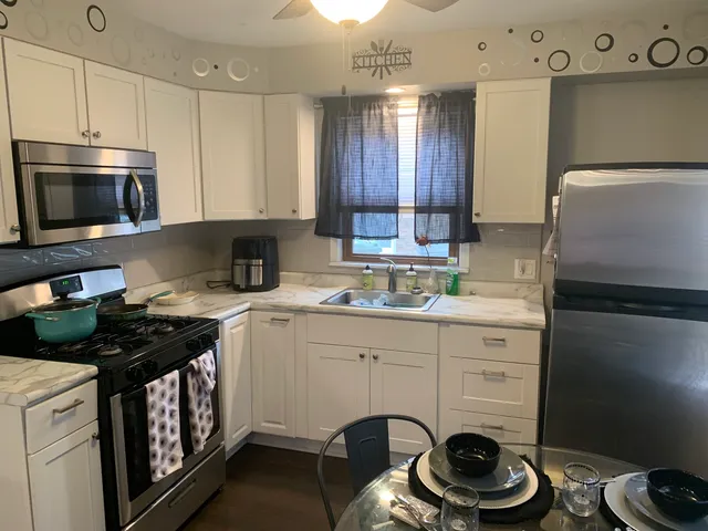 a kitchen with a stove a sink and cabinets