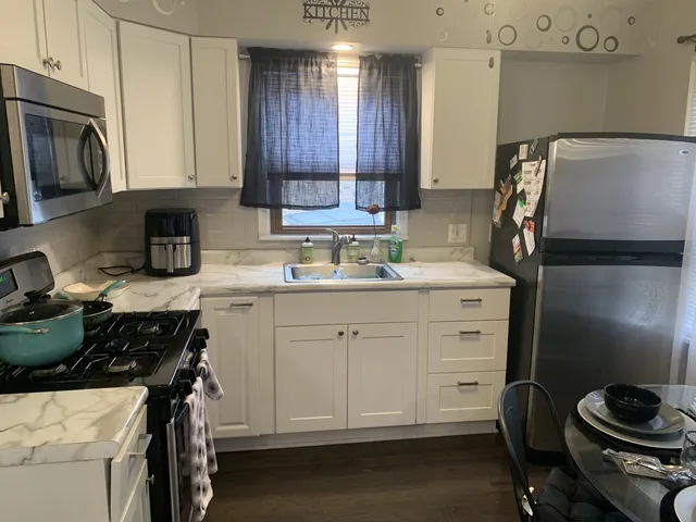 a kitchen with a sink appliances and cabinets
