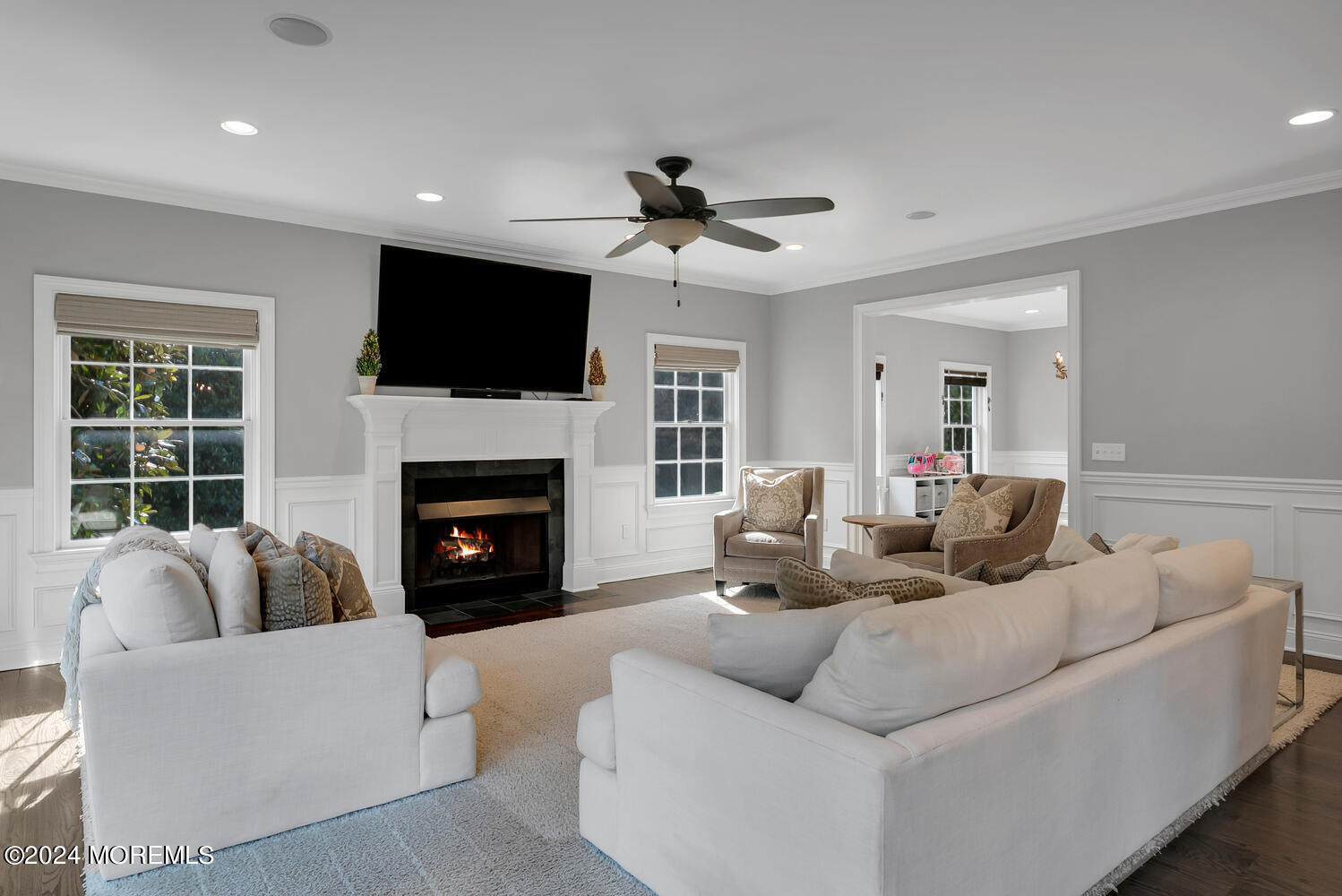 19 Old Phalanx Road Lincroft, NJ 07738 - Photo 13 of 68 a living room with furniture a fireplace and a flat screen tv