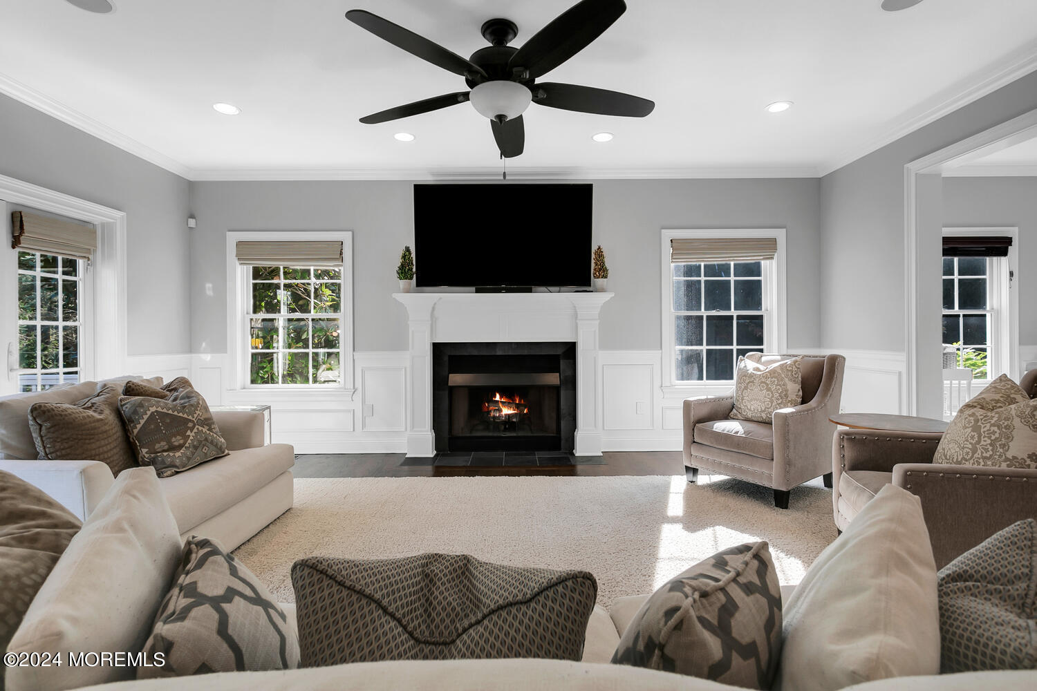 19 Old Phalanx Road Lincroft, NJ 07738 - Photo 14 of 68 a living room with furniture a flat screen tv and a fireplace