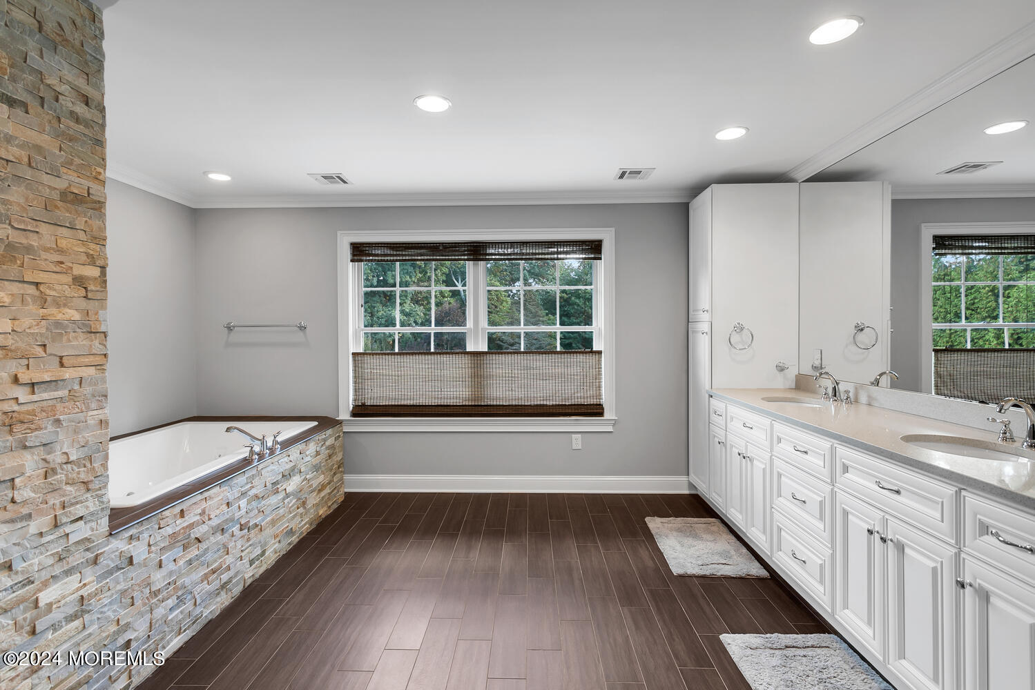 19 Old Phalanx Road Lincroft, NJ 07738 - Photo 30 of 68 a bathroom with a double vanity sink a large mirror and a bathtub