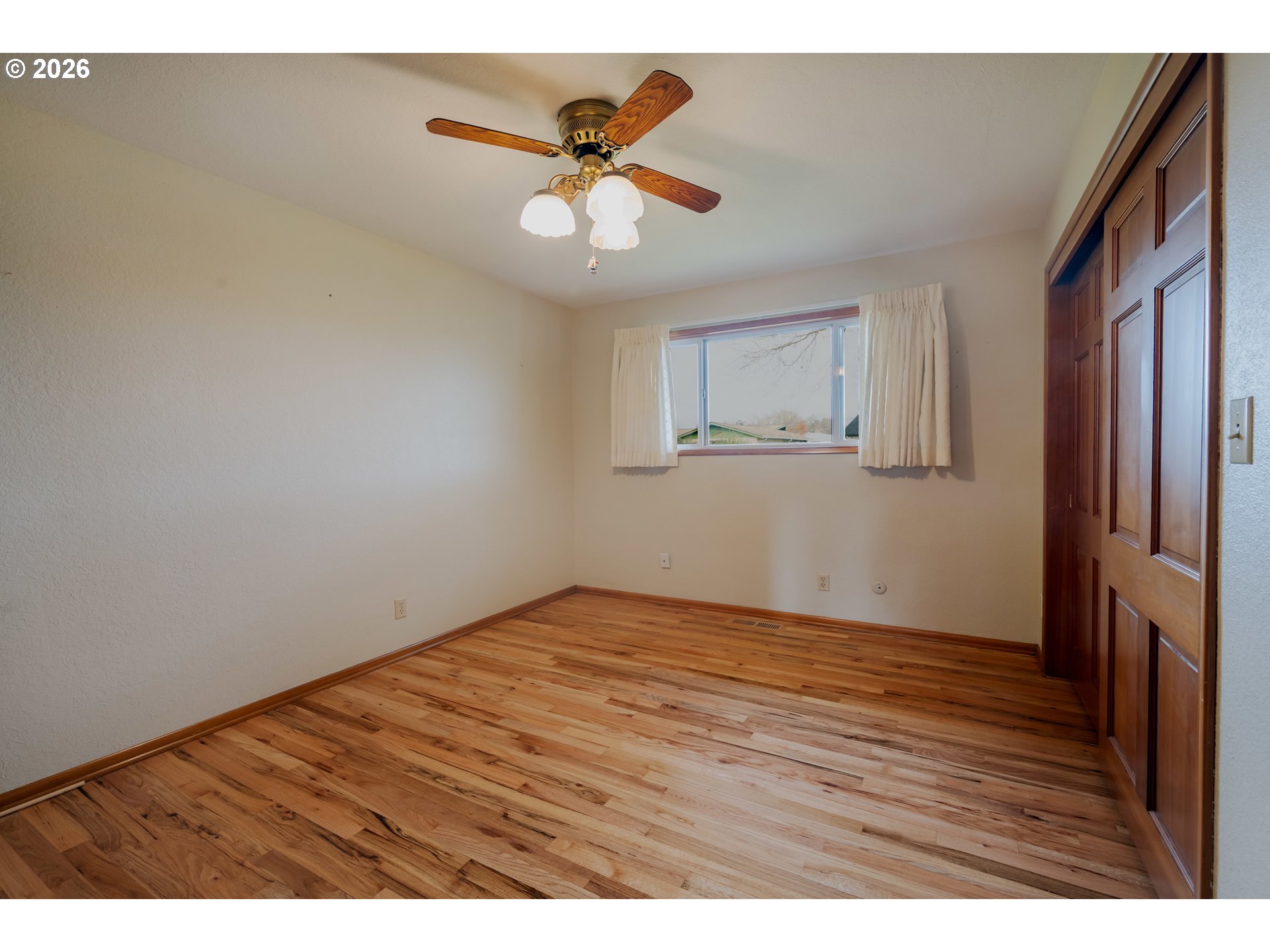 4290 Ivory Way Northeast Salem, OR 97305 - Photo 26 of 42 a view of an empty room with wooden floor and a window