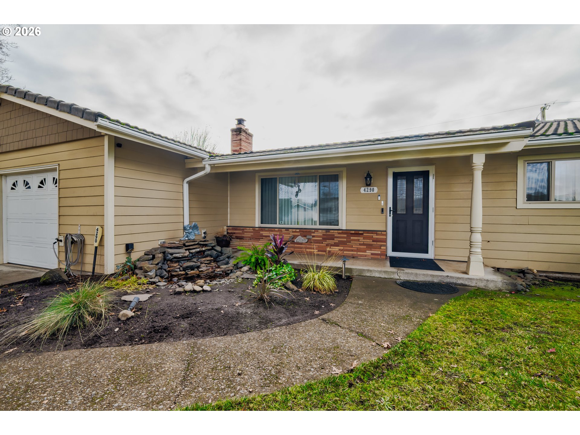 4290 Ivory Way Northeast Salem, OR 97305 - Photo 38 of 42 a view of a house with a small yard and plants