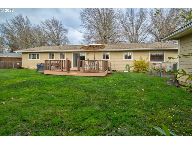 a view of house with a yard and potted plants