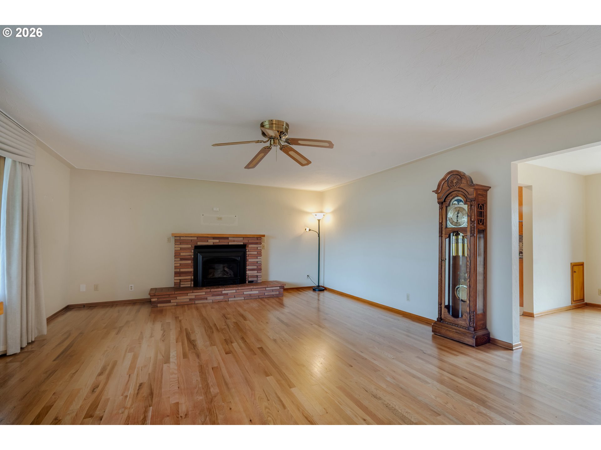 4290 Ivory Way Northeast Salem, OR 97305 - Photo 7 of 42 a view of empty room with wooden floor and fireplace