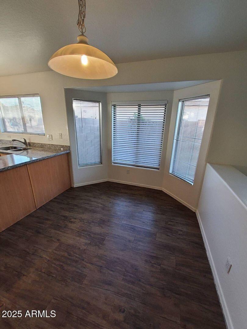 4335 West Carson Road Laveen, AZ 85339 - Photo 4 of 12 an empty room with wooden floor and windows