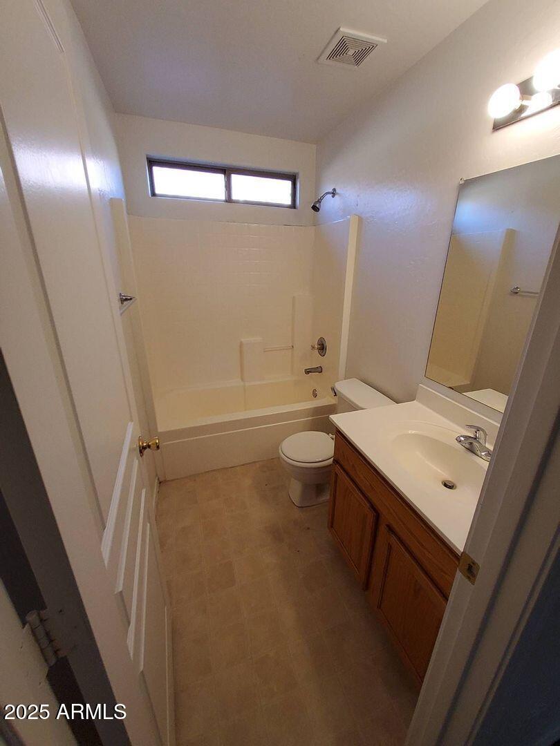 4335 West Carson Road Laveen, AZ 85339 - Photo 9 of 12 a bathroom with a sink a toilet and shower