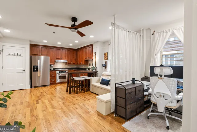 a living room with furniture and kitchen view