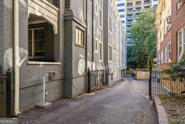 a view of a brick house with many windows