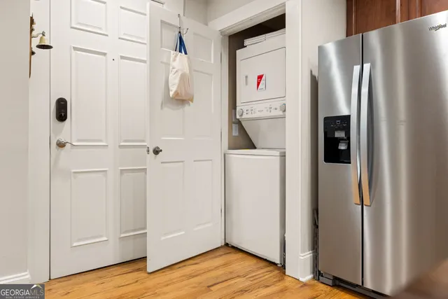 a white refrigerator freezer and a wooden floor