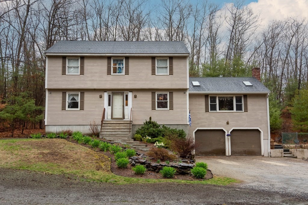 114 Leslie Road Rowley, MA 01969 - Photo 1 of 42 a front view of a house with a garden