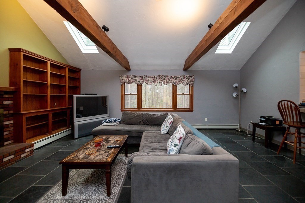114 Leslie Road Rowley, MA 01969 - Photo 20 of 42 a living room with furniture and a flat screen tv