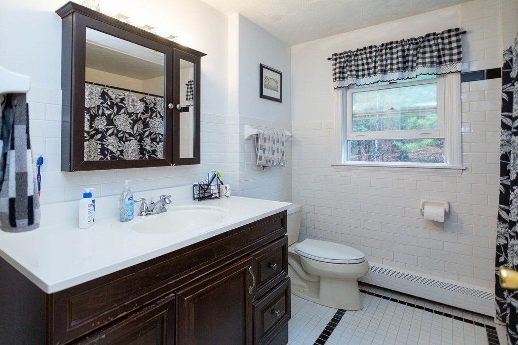 114 Leslie Road Rowley, MA 01969 - Photo 21 of 42 a bathroom with a sink a toilet and a window