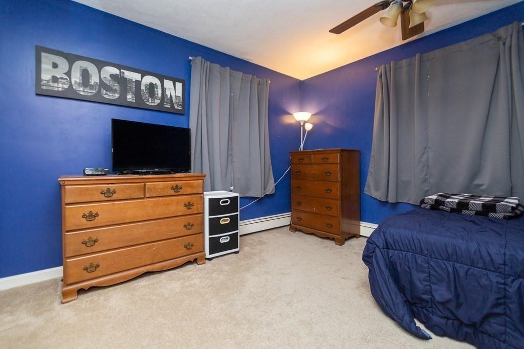 114 Leslie Road Rowley, MA 01969 - Photo 29 of 42 a living room with furniture and a flat screen tv