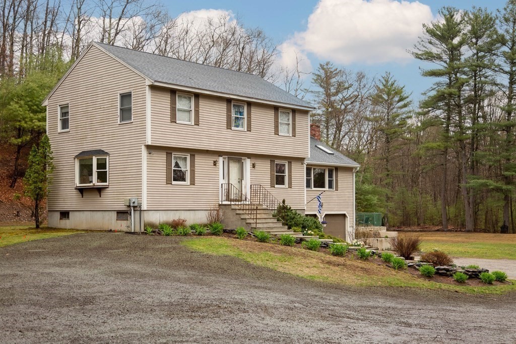 114 Leslie Road Rowley, MA 01969 - Photo 3 of 42 a front view of a house with a yard
