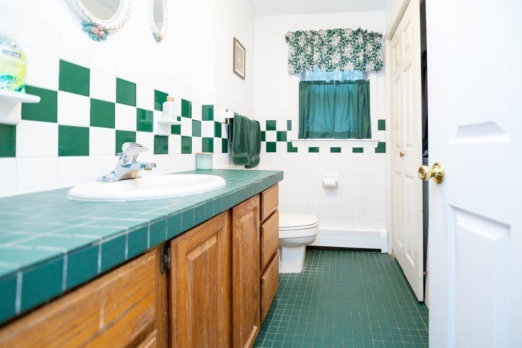 114 Leslie Road Rowley, MA 01969 - Photo 36 of 42 a bathroom with a sink a toilet and shower