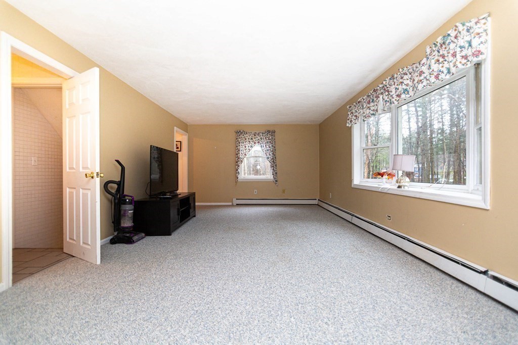 114 Leslie Road Rowley, MA 01969 - Photo 4 of 42 a view of livingroom with furniture workspace and windows