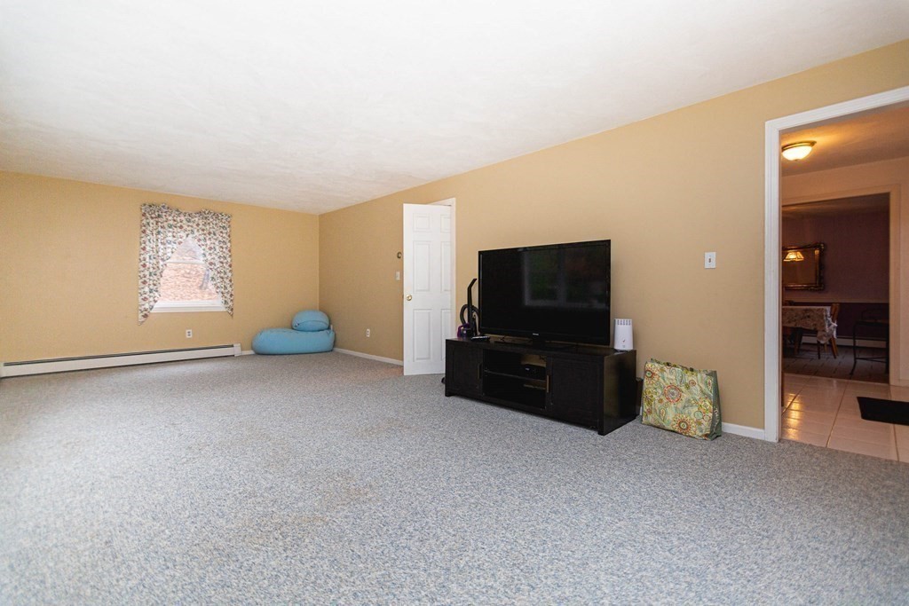 114 Leslie Road Rowley, MA 01969 - Photo 5 of 42 a living room with furniture and a flat screen tv