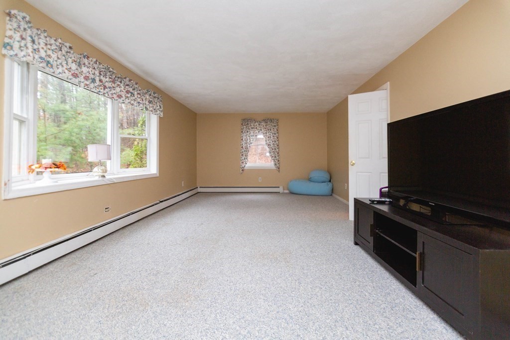 114 Leslie Road Rowley, MA 01969 - Photo 6 of 42 a living room with furniture and a flat screen tv