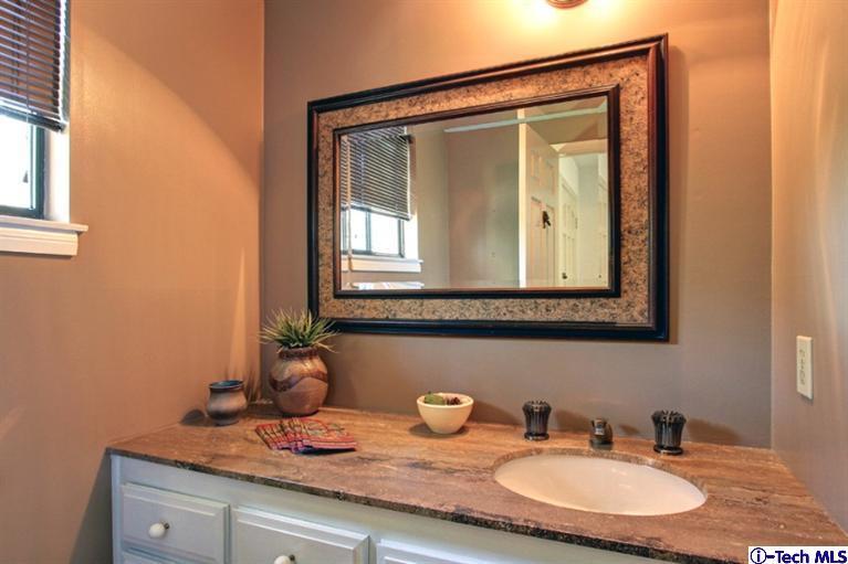 494 California Terrace Pasadena, CA 91105 - Photo 14 of 25 a bathroom with a granite countertop sink and a mirror