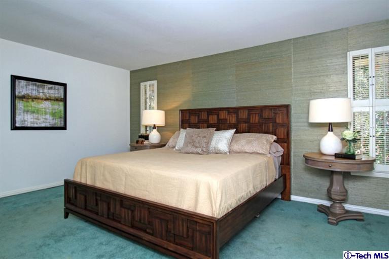 494 California Terrace Pasadena, CA 91105 - Photo 15 of 25 a large bed sitting in a room next to a lamp with a lamp and a window