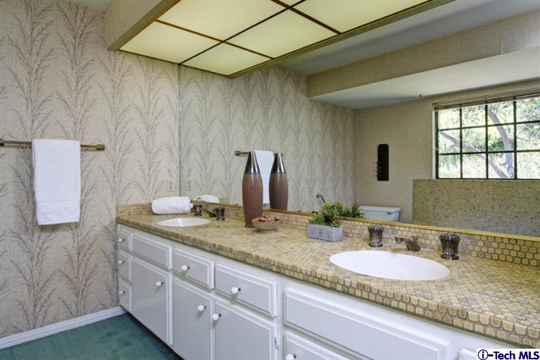 494 California Terrace Pasadena, CA 91105 - Photo 17 of 25 a bathroom with a granite countertop sink and a mirror