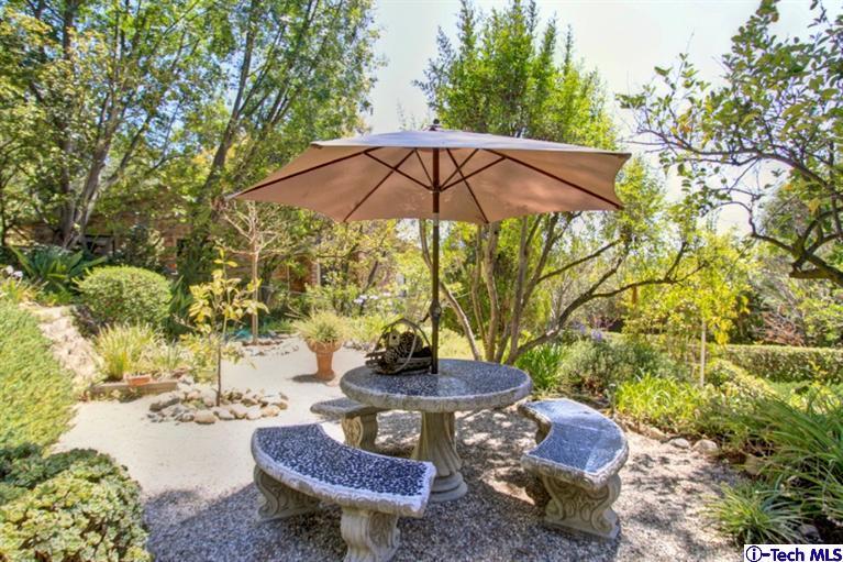 494 California Terrace Pasadena, CA 91105 - Photo 23 of 25 a view of a backyard with table and chairs under an umbrella