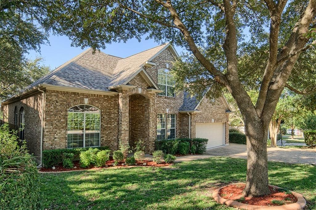 3404 Oxsheer Drive Austin, TX 78732 - Photo 2 of 15 a front view of a house with a garden and trees
