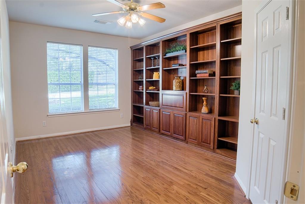 3404 Oxsheer Drive Austin, TX 78732 - Photo 5 of 15 a view of an empty room with a window and wooden floor