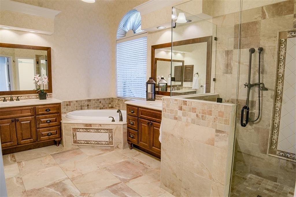 3404 Oxsheer Drive Austin, TX 78732 - Photo 7 of 15 a spacious bathroom with a granite countertop sink a mirror and a bathtub