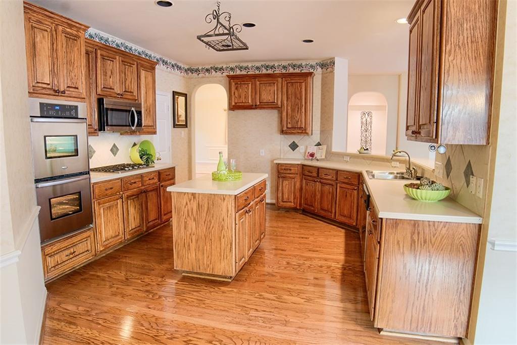 3404 Oxsheer Drive Austin, TX 78732 - Photo 9 of 15 a kitchen with stainless steel appliances granite countertop a stove a sink dishwasher and a refrigerator with wooden floor