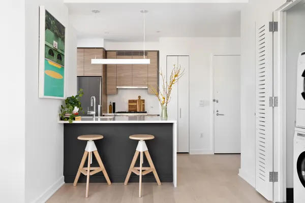 a kitchen with stainless steel appliances a sink and a refrigerator
