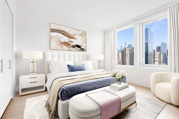 a bedroom with two beds and a large window with garden view