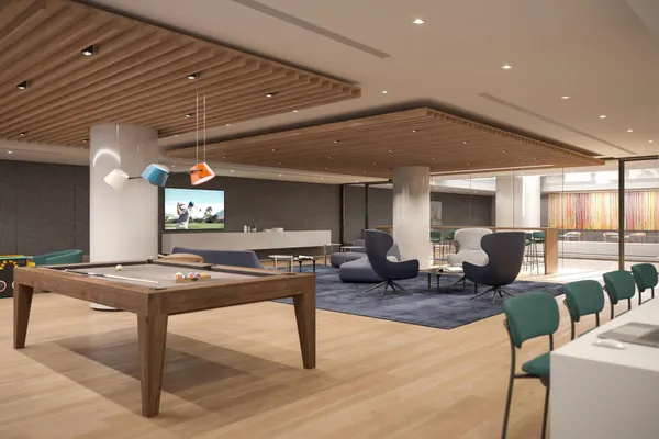 a living room with couches a table and chairs with wooden floor