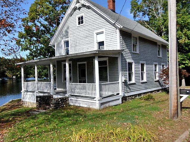 a view of house with a yard