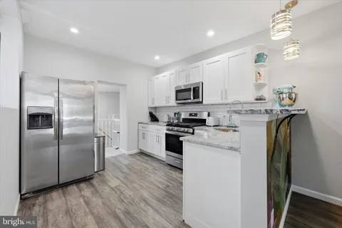 a kitchen with stainless steel appliances a refrigerator sink and microwave