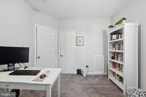 a view of a workspace with furniture and a flat screen tv