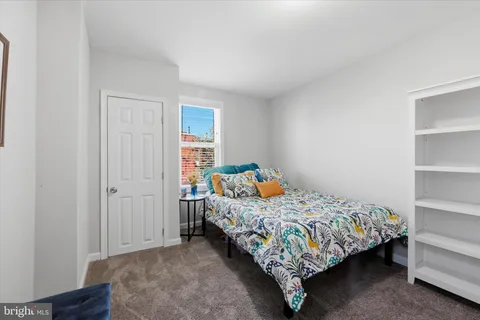 a bedroom with a bed and a closet