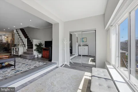 a view of a hallway with living room and dining room